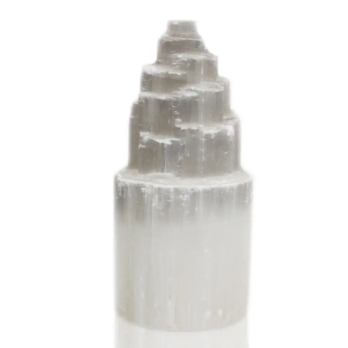 A translucent pale gray selenite tower lamp with a stepped pyramid top and smooth cylindrical base in 20 cm size