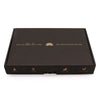 Black rectangular serenity essential self care kit box with gold lotus design and mindfulness gift label