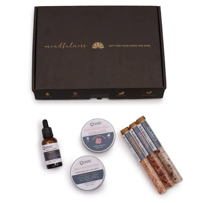 Dark brown gift box with gold foil mindfulness lettering and lotus logo for serenity essential self care kit set includes items for home and mind