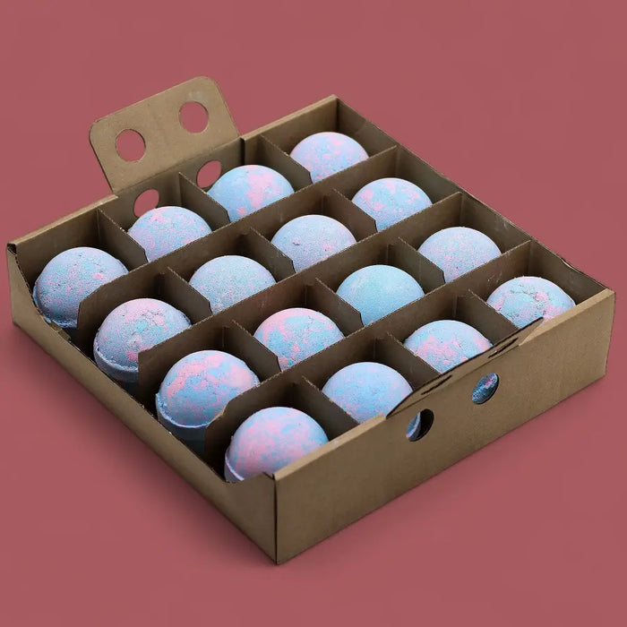 A set of 3 pastel blue and pink bath bombs with a speckled texture scented with baby powder