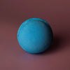 A round vibrant blue bath bomb with a textured surface from a set of 3 blueberry bath bombs