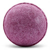 A round purple bath bomb with a textured surface and subtle speckling from a set of 3 bath bombs cherry