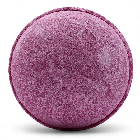 A round purple bath bomb with a textured surface and subtle speckling from a set of 3 bath bombs cherry