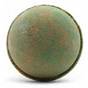 A round textured bath bomb with green and rust colors from a set of 3 bath bombs hawaiian mango
