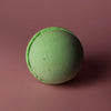 A round matte lime green bath bomb with a textured surface and ring detail from a set of 3 lemon eucalyptus bath bombs