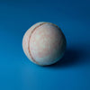A round textured bath bomb with soft pink and pale blue marble colors from the peach sangria bath bombs set