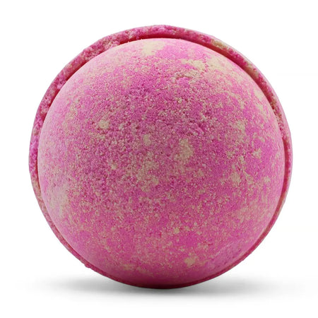 A round textured pink lemonade bath bomb with beige speckles and a slightly rough surface in a set of three bath bombs