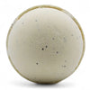 Cream-colored simply vanilla bath bomb with a textured surface and small black speckles in a set of 3 bath bombs