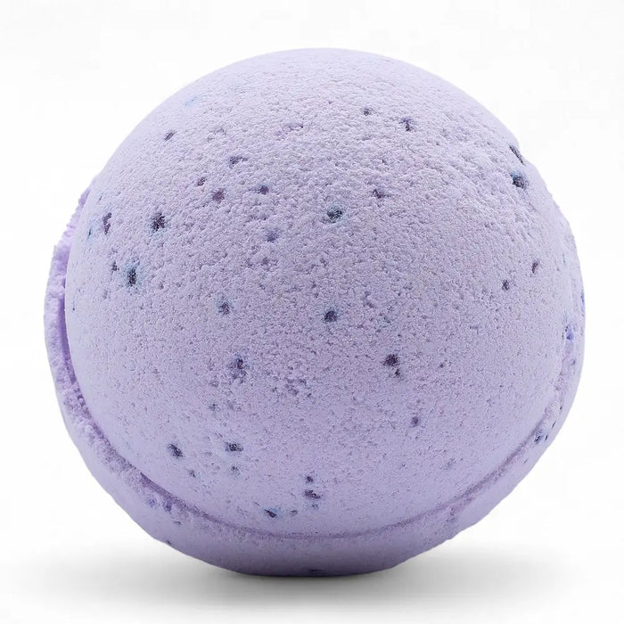 A lavender bath bomb with dark purple flecks from a set of 3 bath bombs scented with sweet fennel and jojoba