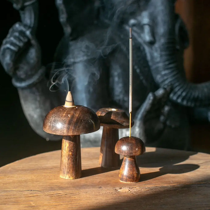 Set of 3 dark brown mango wood mushroom incense holders with smooth polished surfaces and natural wood grain detail