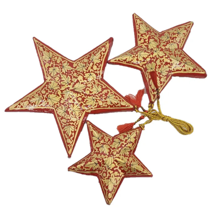 Set of 3 hand-painted red and gold papier maché star ornaments with leaf patterns connected by golden cord and tassels