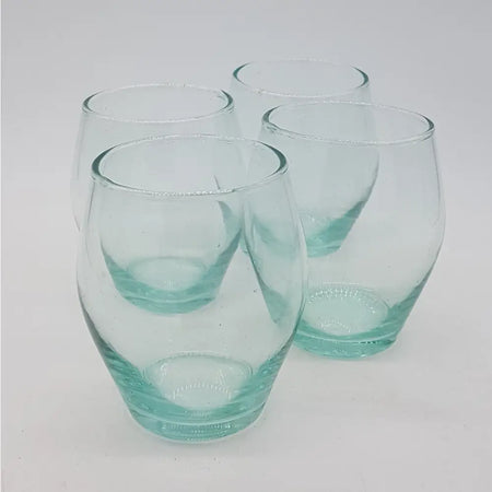 Set of 4 hand-blown recycled glass tumblers with a teal tint and textured bases made from clear glass