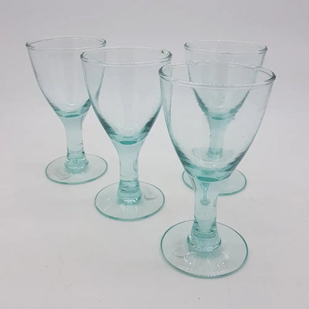 Set of four translucent light blue hand blown recycled glass wine glasses with slender stems in two sizes