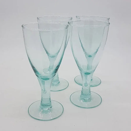 Set of four translucent light blue recycled glass wine glasses with slender stems in two sizes and circular bases
