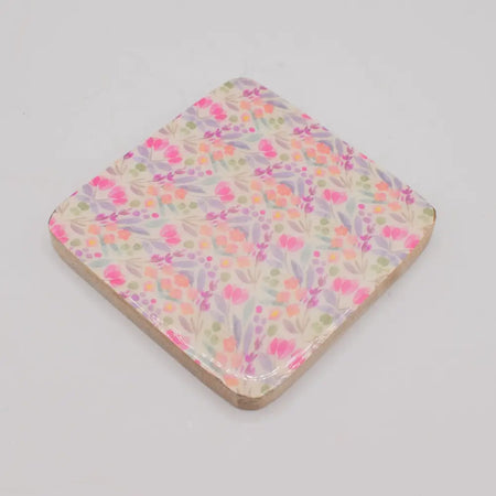 A set of 4 square coasters with a glossy finish featuring a delicate floral pattern in soft pinks and greens