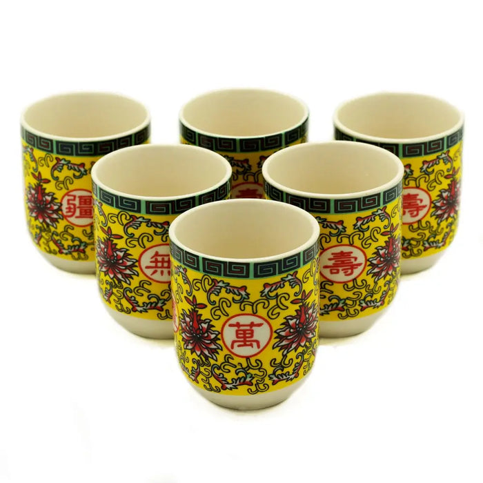 Set of six yellow ceramic herbal tea cups with red floral motifs and chinese characters long life oriental design