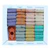 A neatly arranged set of colorful incense smudge bricks in a white box from the wild west collection