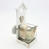White distressed wooden tealight holder shaped like a birdhouse with heart cutout and lace wrapped candle jar