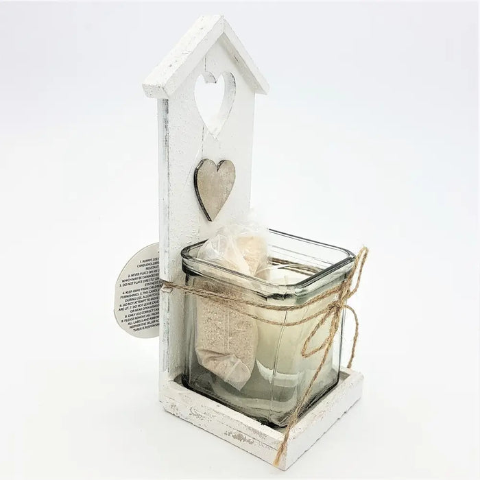 White distressed wooden tealight holder shaped like a birdhouse with heart cutout and lace wrapped candle jar