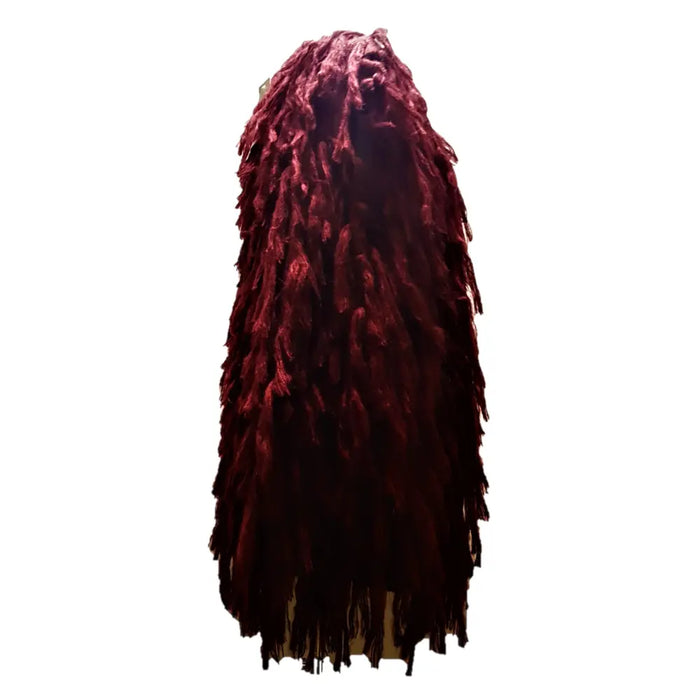 A deep burgundy long shaggy wig with thick textured dreadlock strands shown with a soft-knit sleeveless jacket in three colours