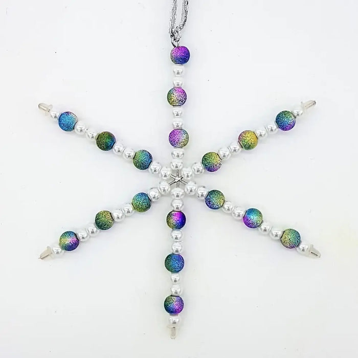 A silver snowflake hanging decoration made of iridescent purple blue green beads and silver metallic rainbow beads