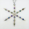 A silver snowflake hanging decoration with shimmering rainbow beads and silver beads on a metallic ribbon