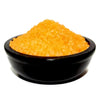 A sleek black ceramic bowl holding vibrant orange coarse simmering granules cinnamon and orange flavor