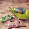 A vibrant lime green pear-shaped ceramic bowl with a metallic rim holding simmering granules coconut