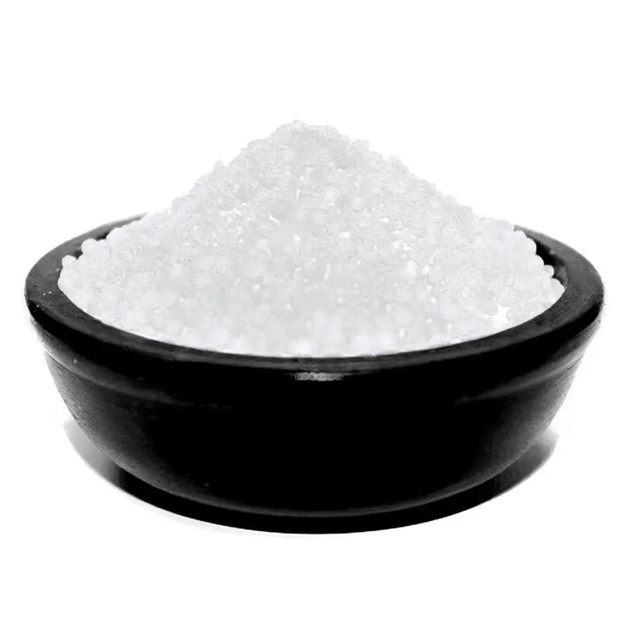 A black ceramic bowl filled with coarse white simmering granules for frankincense use
