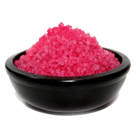 Vibrant pink crystalline simmering granules bath salts in a sleek black ceramic bowl rose musk scent