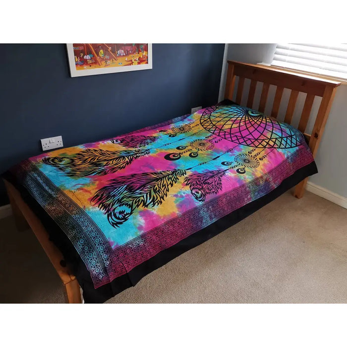 Single cotton bedspread with vibrant tie-dye rainbow colors featuring black feather dreamcatcher design as wall hanging