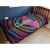A vibrant rainbow-colored cotton bedspread wall hanging with an intricate elephant head mandala on black background