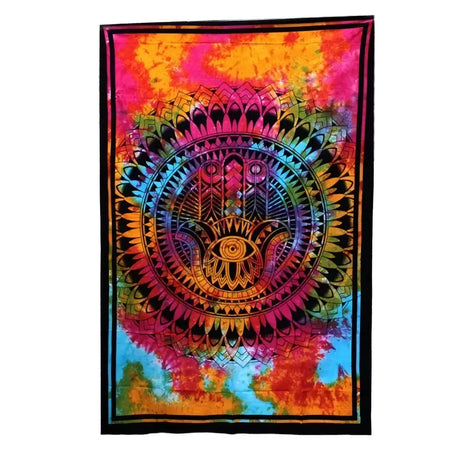 Vibrant cotton bedspread and wall hanging with a central hamsa hand and rainbow tie dye geometric patterns