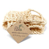 Beige sisal bath scrub made of woven natural fibers with a textured looped design for exfoliating the back