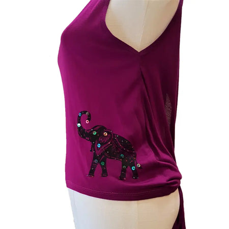 A vibrant magenta sleeveless open-back top with a black sequined elephant print and colorful embellishments