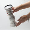 Small whitewash candle stand made of distressed mango wood with stacked ringed tiers and a flat top surface