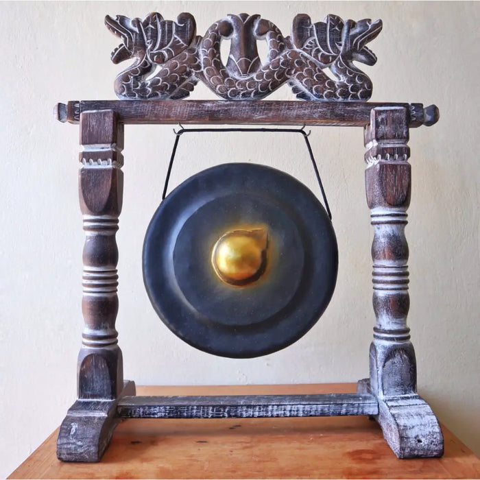Small healing gong on stand with a dark wood frame, ornate dragon carvings, and a central golden bell in black 25cm