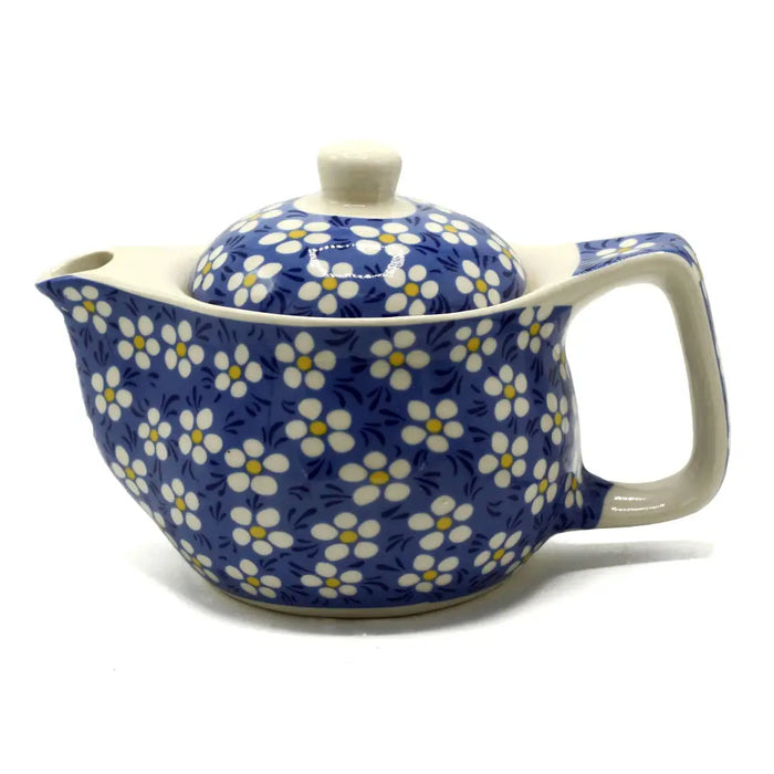 Small herbal teapot with a blue daisy ceramic body and cream handle for brewing herbal tea cups