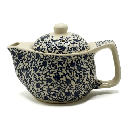 Cream-colored ceramic small herbal teapot with intricate navy blue floral and vine patterns for herbal tea cups