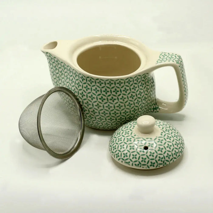 Small herbal teapot with green mosaic ceramic body, cream lid, geometric leaf pattern, and removable metal infuser