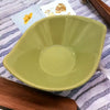 A small olive green leaf shaped ceramic plate with a glossy finish in olive green brown and ivory tones