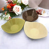 Three small leaf-shaped ceramic plates in olive green brown and ivory with a glossy finish