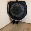 Dark blue circular cotton beach towel with teal and white mandala pattern and fringed edges peacock blues design