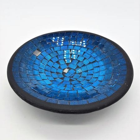 Small mosaic tile dish with vibrant blue glass tiles in concentric circles and a dark black rim
