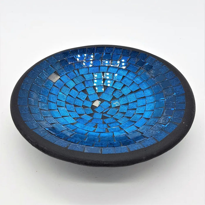 Small mosaic tile dish with vibrant blue glass tiles in concentric circles and a dark black rim