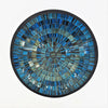 Small mosaic tile dish in blue with gold glitter featuring a circular mosaic design with concentric textured rings and dark border