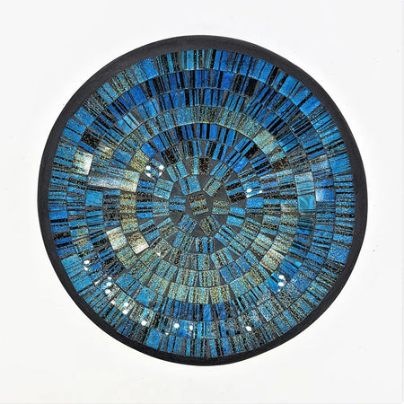 Small mosaic tile dish in blue with gold glitter featuring a circular mosaic design with concentric textured rings and dark border