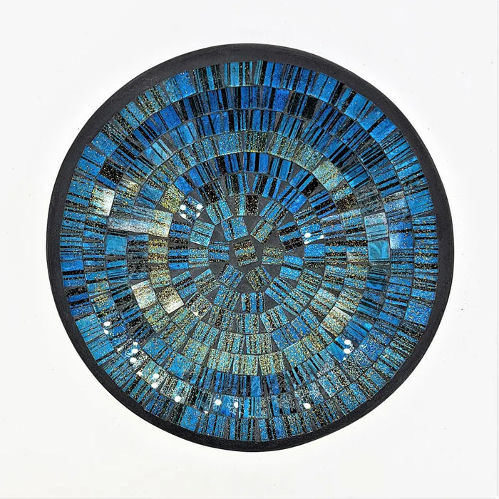 Small mosaic tile dish in blue with gold glitter featuring a circular mosaic design with concentric textured rings and dark border