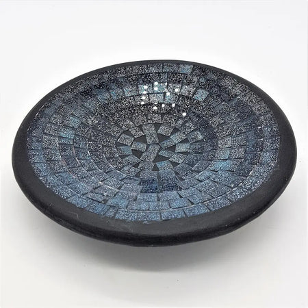 Small mosaic tile dish with dark blue black rim and intricate pattern of blue gray speckled glass tiles in circles