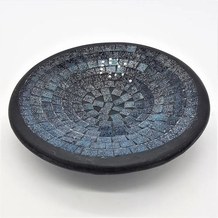 Small mosaic tile dish with dark blue black rim and intricate pattern of blue gray speckled glass tiles in circles